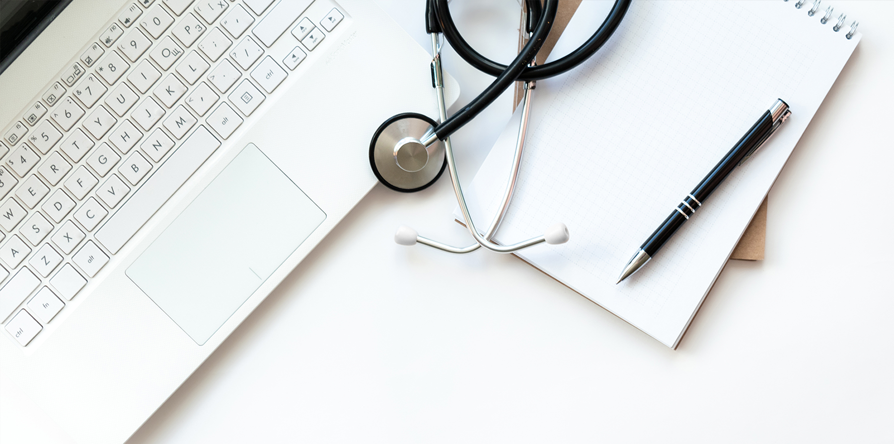 Doctors desk with computer and stethoscope